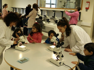 Crianças observam ao microscópio